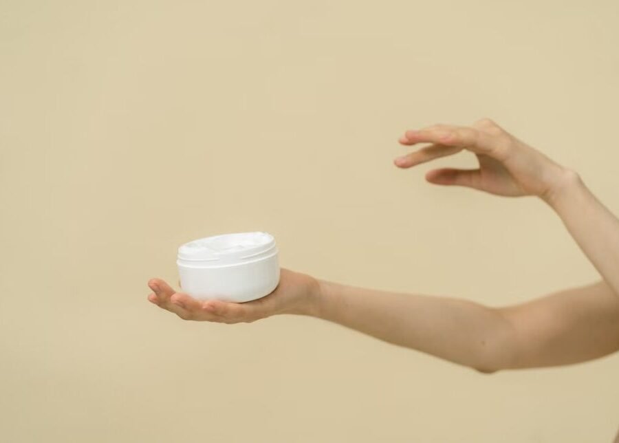 Best tattoo aftercare lotion for sensitive skin — unlabeled fragrance-free lotion jar next to bare skin