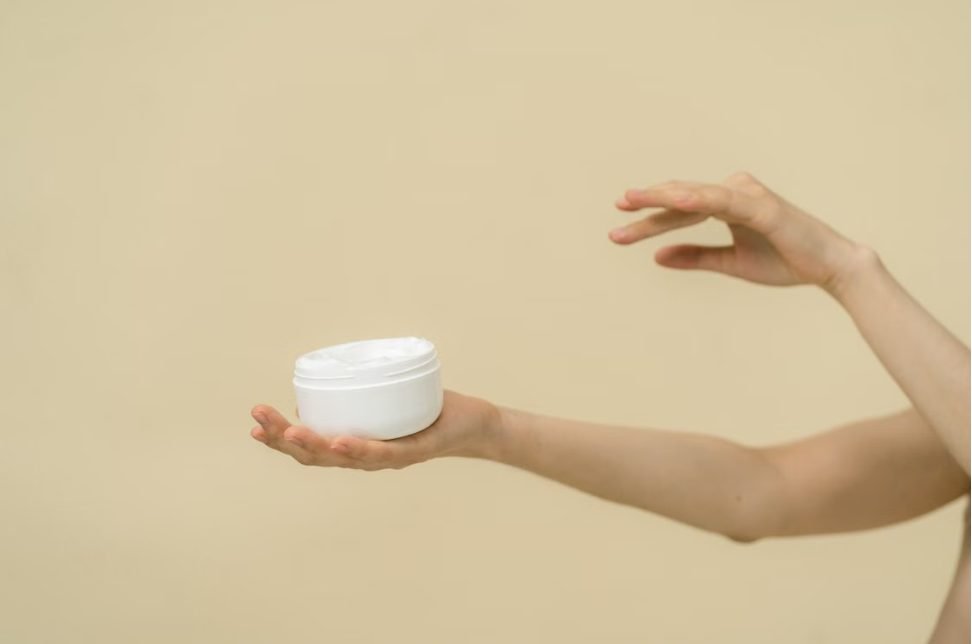 Best tattoo aftercare lotion for sensitive skin — unlabeled fragrance-free lotion jar next to bare skin