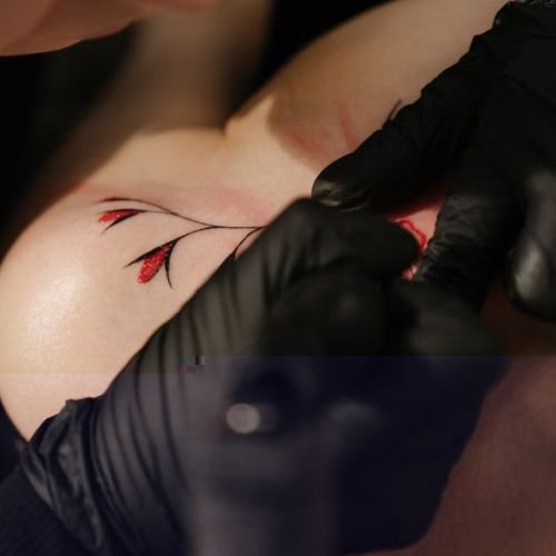 Delicate botanical design in the fine line tattoo style on a forearm