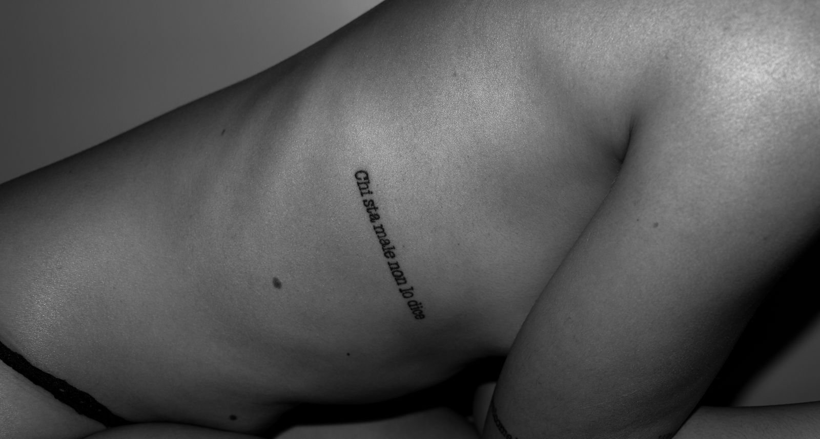 Rib tattoo pain during a side-torso session, the placement our pain chart rates very high