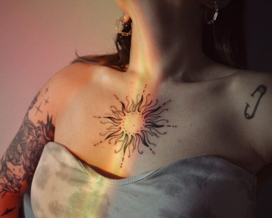 Symmetrical sternum tattoo on a woman’s chest, showing the placement over the breastbone