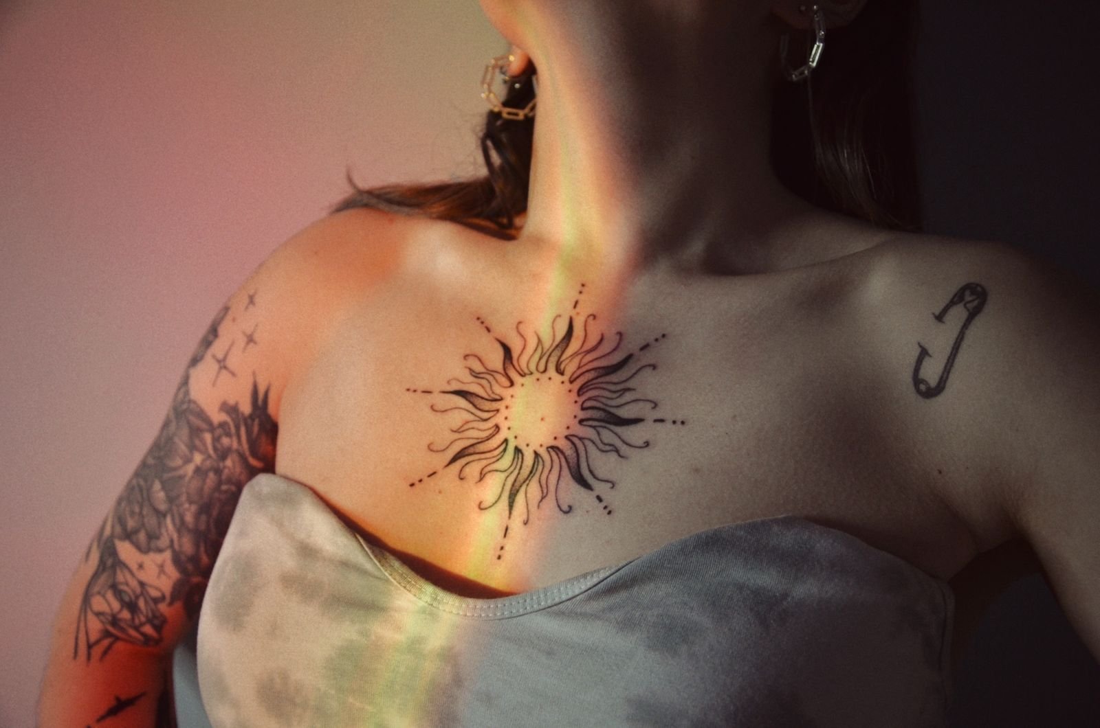 Symmetrical sternum tattoo on a woman’s chest, showing the placement over the breastbone