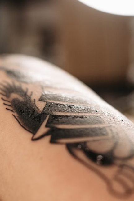 Is tattoo scabbing normal — close-up of a healing tattoo with light scabbing during the normal aftercare process
